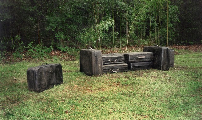 In tran/sit, 2002 / Cast solid concrete and metal / Life size suitcases